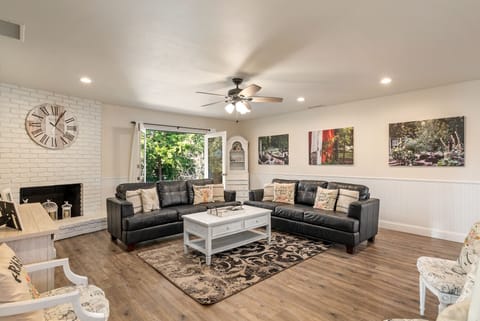Formal Living Room with Large Smart TV and View of Seasonal Flower Garden