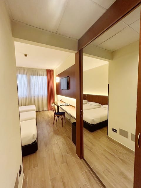 Standard Triple Room | Minibar, in-room safe, desk, blackout drapes