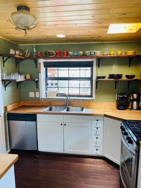 The kitchen features hardwood floors, as found throughout the cabin and hut.