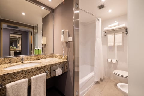 Suite, 1 King Bed, City View | Bathroom | Combined shower/tub, deep soaking tub, eco-friendly toiletries