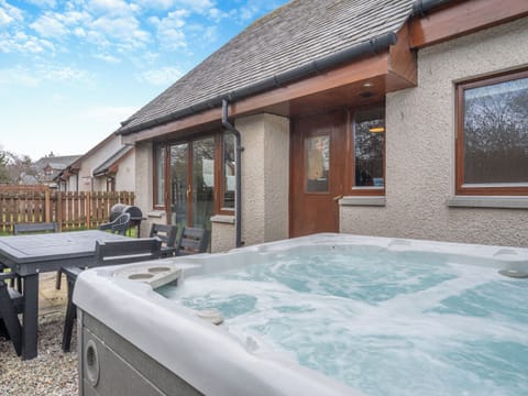 Relax in the lovely hot tub | Croftside House - Allt Mor Cottages, Aviemore