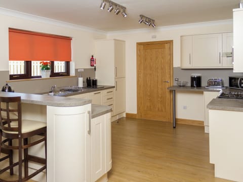 Modern fitted kitchen with breakfast bar | Seascape - Seascape Cottages, Southerness, near Dumfries