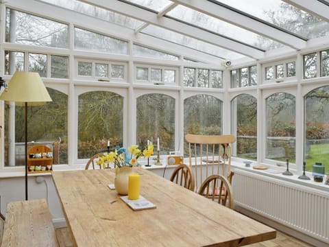 Large dining table in the conservatory | Jubilee Cottage, Church Enstone, near Chipping Norton