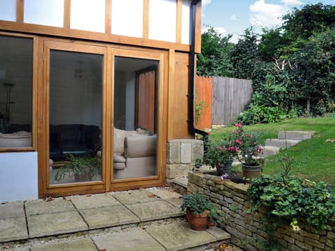 The sun room has French doors which open out to the rear garden | Orchard House, Chipping Campden