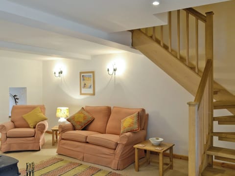 Cosy lounge with access to stairs to upper level | Honey Cottage - Bramble Cottage and Honey Cottage, Newland, near Coleford