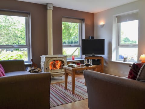 Spacious living and dining room with wood burner | Tre Anna Lodge, Dwyran, near Llanfairpwllgwyngyll