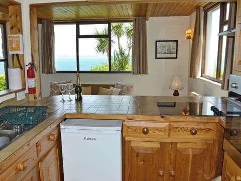 Inviting kitchen area with breakfast bar | Berlewen - Polhaun Holiday Apartments, Mevagissey, near St Austell