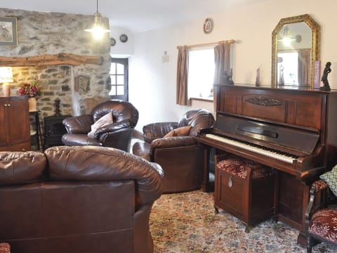 Living room with inglenook fireplace and period furniture | Cae Bach Cottage, Dinas, Lleyn Peninsula