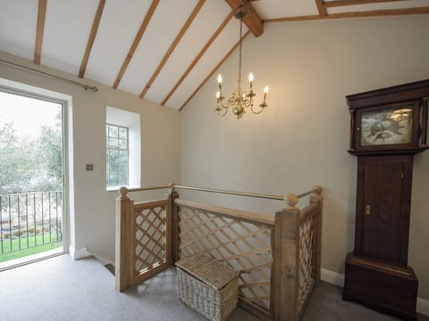 Stairs to landing with French doors leading to balcony | Holliers Cottage, Middle Barton, near Chipping Norton
