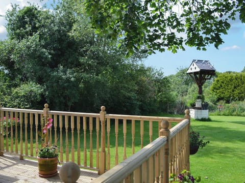Decking with view over garden | Hunter&rsquo;s Cottage - Llwyn Ffynnon, Y Ff&ocirc;r, near Pwllheli