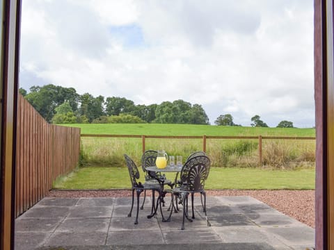 Double doors from kitchen leading to rear patio and garden | The Ploughmans - Loch Lomond Farm Cottages, Balfron Station, near Stirling
