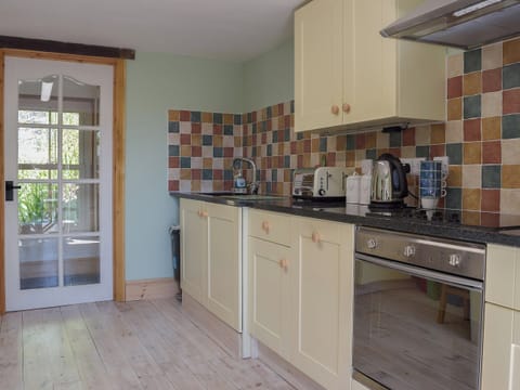 Well-appointed kitchen with granite tiled worktops | Woodlands, Laugharne, near Pendine