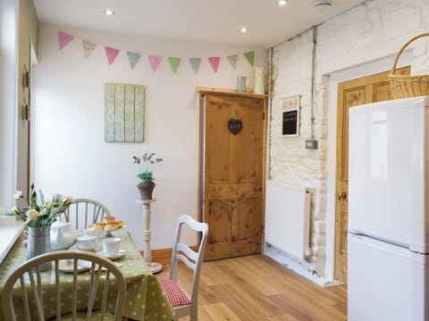 Galley style kitchen with breakfast bar | Moss Cottage, Burry Port, near Llanelli