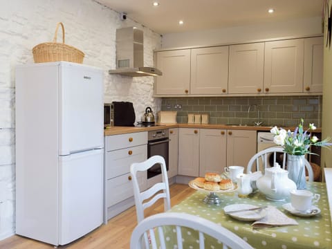 Galley style kitchen with breakfast bar | Moss Cottage, Burry Port, near Llanelli