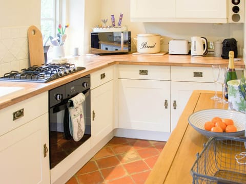 Well equipped galley style kitchen with gorgeous quarry tiled floor | Penny Cottage, Bonsall, near Matlock