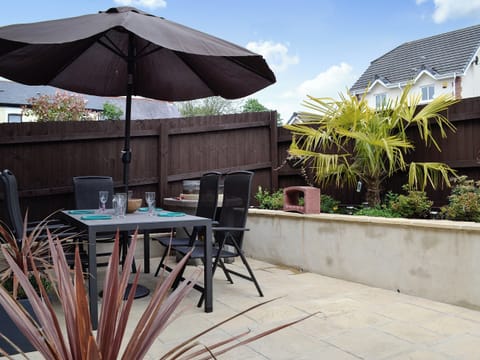Outdoor dining area with BBQ | Ty Cerrig, Cwmgors, near Ammanford