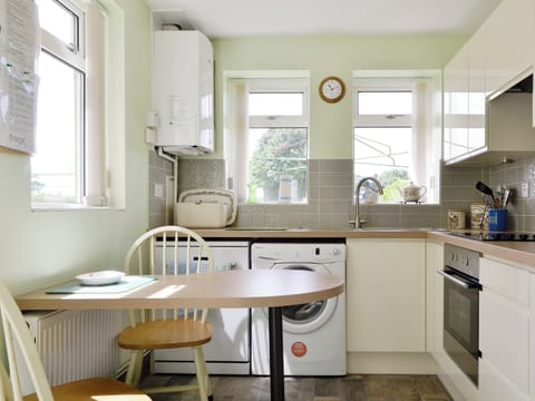 Farmhouse style kitchen with informal dining area | Hazeldene - Murton Farm, Murton, near Swansea