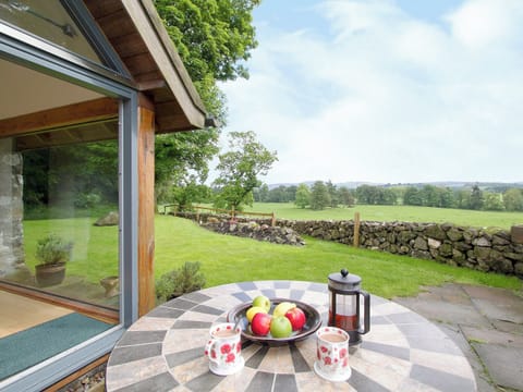 Take advantage of the glorious views from the sitting-out-area | Tullibole Castle Longhouse, Crook of Devon