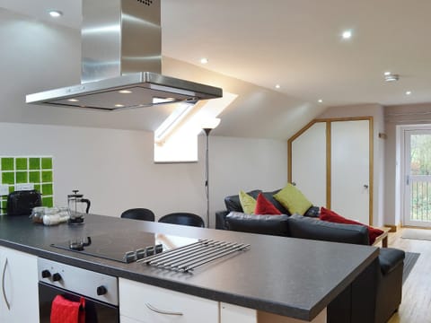 Kitchen providing island cooking and a breakfast bar | The Loft - Lluest Cottages, Neuaddlwyd, near Aberaeron