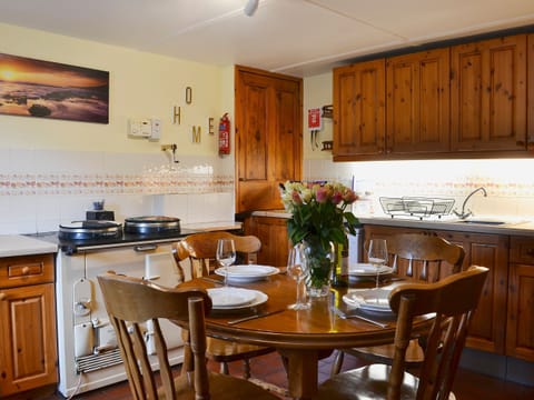 Well-equipped kitchen and dining area | West End Cottage, Carrbridge, near Aviemore