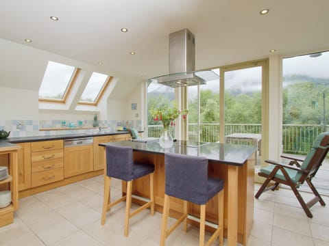 Spacious and well-equipped kitchen area with French doors leading to the balcony | Carness West, North Ballachulish, Glencoe