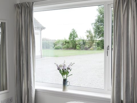 View of front garden from the bedroom | Barn Owl Cottage, Newton, near Tain