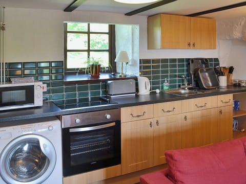 Tiled kitchen area | The Hayloft Barn - Tyddyn Iolyn, near Criccieth