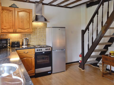 Spacious kitchen with stairs to upper level | Y Bwthyn, Bala