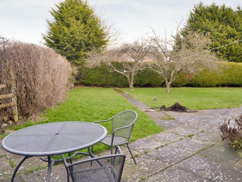 Paved patio with outdoor furniture | The Coach House at Old Vicarage Cottage, Betws-yn-Rhos, near Abergele