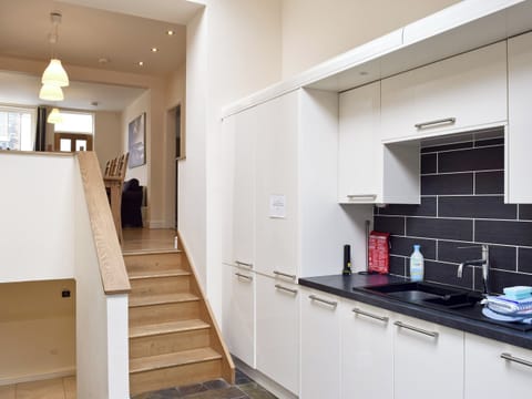 Fitted kitchen with stairs down to lower level | Falcon Crag, Keswick