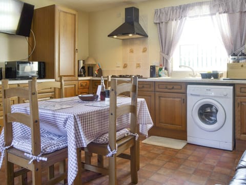 Convenient dining area within kitchen | Cefn Helyg Bach, Cemaes Bay