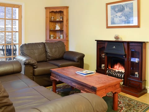 Light, bright and airy living/dining room with door to the patio | The Stables at Old Vicarage Cottage, Betws-Yn-Rhos