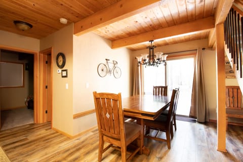 Dining Area- dining table has a bench on one side and extends out to fit 10