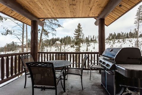 Main level deck with gas grill, outdoor dining, and undisturbed views