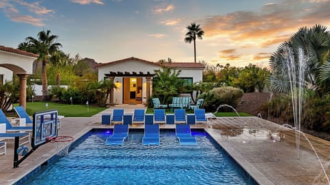 Luxury pool with in-water loungers, fountains & lush landscaping!