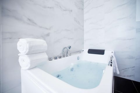 VOYA Suite | Bathroom | Designer toiletries, hair dryer, bathrobes, slippers