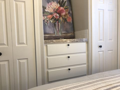 Two closets and a set of drawers in the master bedroom