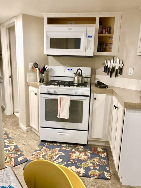Kitchen with a full sized gas stove and oven. Microwave above