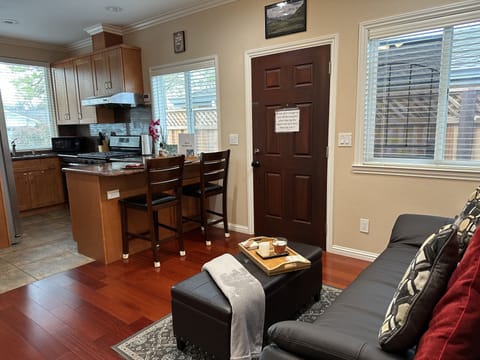 View of living space and kitchen. Entry to unit can be seen on the right.