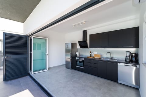 Summer kitchen by the pool and outdoor grill.