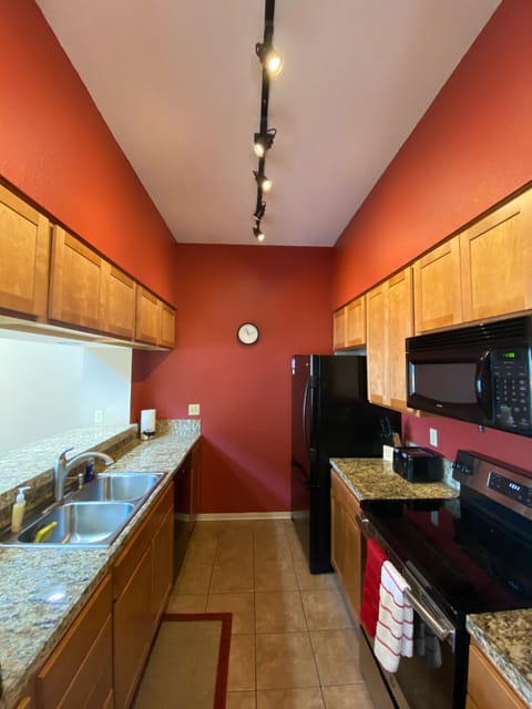 Well equipped kitchen with granite countertops