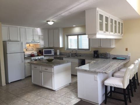 Kitchen with island and counter seating area.