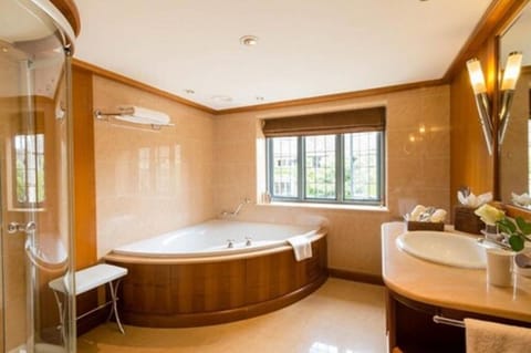 Separate tub and shower, designer toiletries, hair dryer, bathrobes