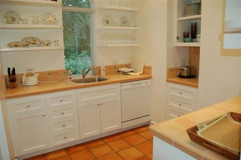 Full kitchen complete with stove, dishwasher, microwave and cookware.