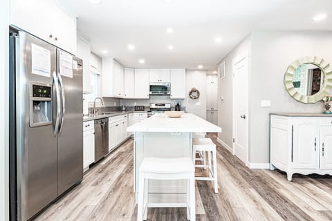 Meal prep is a social affair with barstool seating for four and an open floor plan that extends to the living and dining areas.