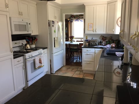 Kitchen with granite counters, extra large oven, fully-equipped, and dishwasher.