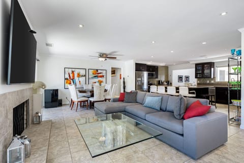 Living Room, sectional, 85 TV, Fireplace, poker table, ceiling lights, paintings