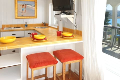 The kitchenette with mini frig is stocked with more Fiesta dishes and glass wear to make it easy to have a snack inside or entertain conveniently out on the deck.