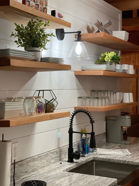 Farmhouse sink and open shelving stocked with everything you need. 