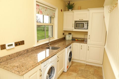 Utility - washing machine, dryer and microwave with hanging area for coats.